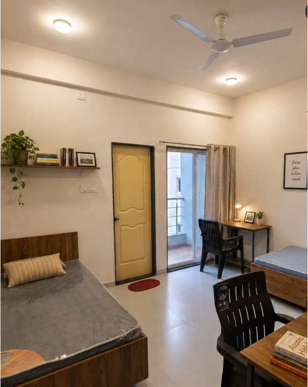 Furnished student room with beds and study desks
